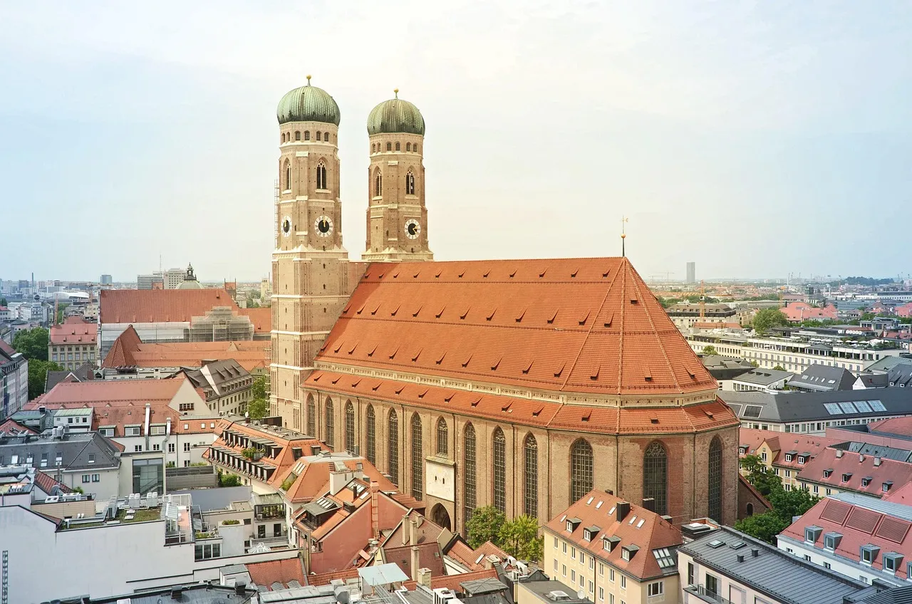 The Frauenkirche's two towers with green domes above the red roofs of Munich's Old Town