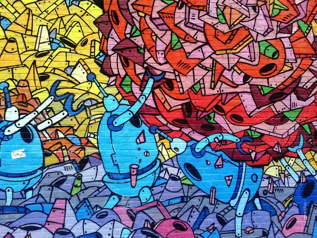 Eine Mauer voller bunter Graffiti mit Robotern und kräftigen Formen
