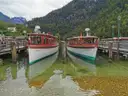 Zwei hölzerne Ausflugsboote an einem Steg am Königssee