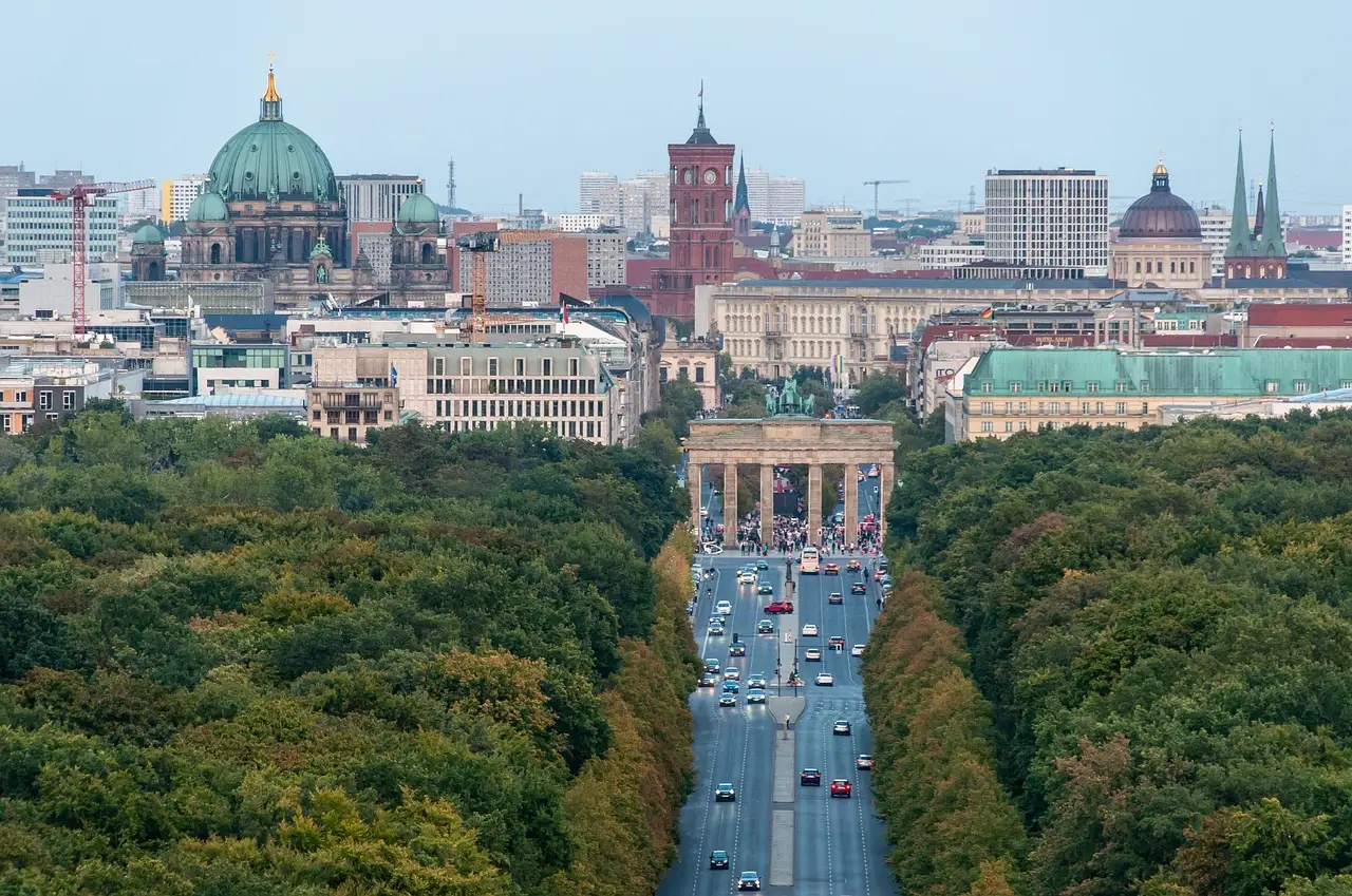 Vista sobre las copas de los árboles del Tiergarten hacia la Puerta de Brandeburgo, la catedral de Berlín y el Ayuntamiento Rojo