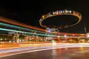 El anillo iluminado de Westheimer sobre Post Oak Boulevard, en el Uptown de Houston de noche, con estelas de luz de los coches