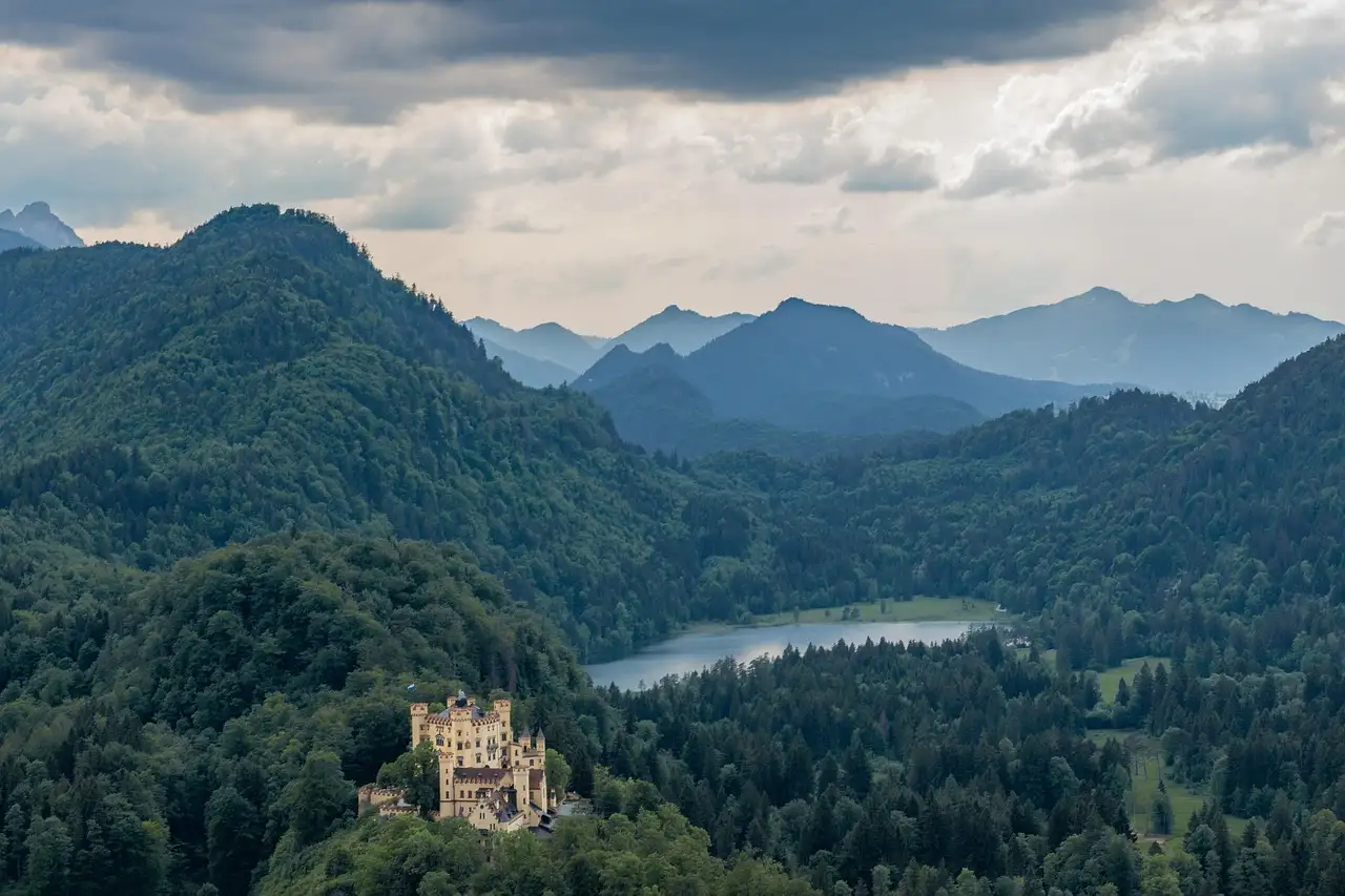 El castillo de Hohenschwangau en el bosque sobre el lago Alpsee, visto desde muy arriba
