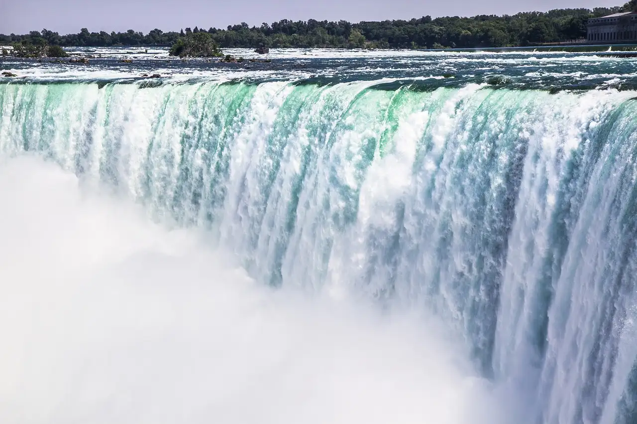 El agua verde cae por el borde de las cataratas Horseshoe
