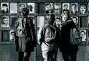 Visitors at the Window of Remembrance at the Berlin Wall Memorial