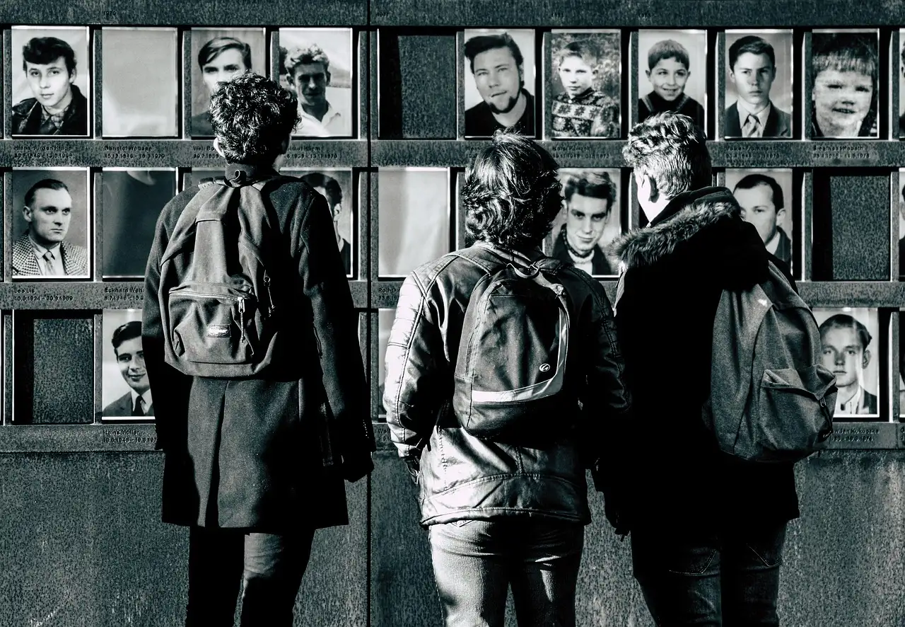Visitors at the Window of Remembrance at the Berlin Wall Memorial