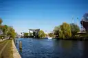The Spree under a blue sky, with the Federal Chancellery and the TV Tower in the distance
