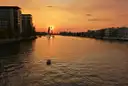 The Spree at sunset, with the Molecule Man sculpture standing in the water