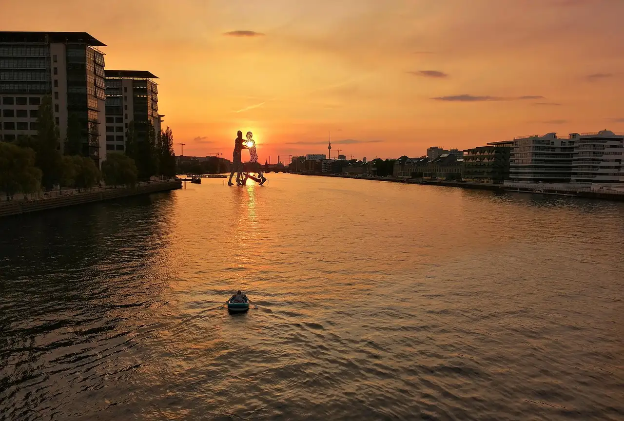 The Spree at sunset, with the Molecule Man sculpture standing in the water