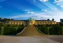 Sanssouci Palace in Potsdam above its terraced vineyard steps under a blue sky
