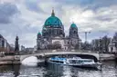 A sightseeing boat on the Spree in front of the Berlin Cathedral