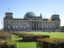 The Reichstag building and its glass dome behind a green lawn