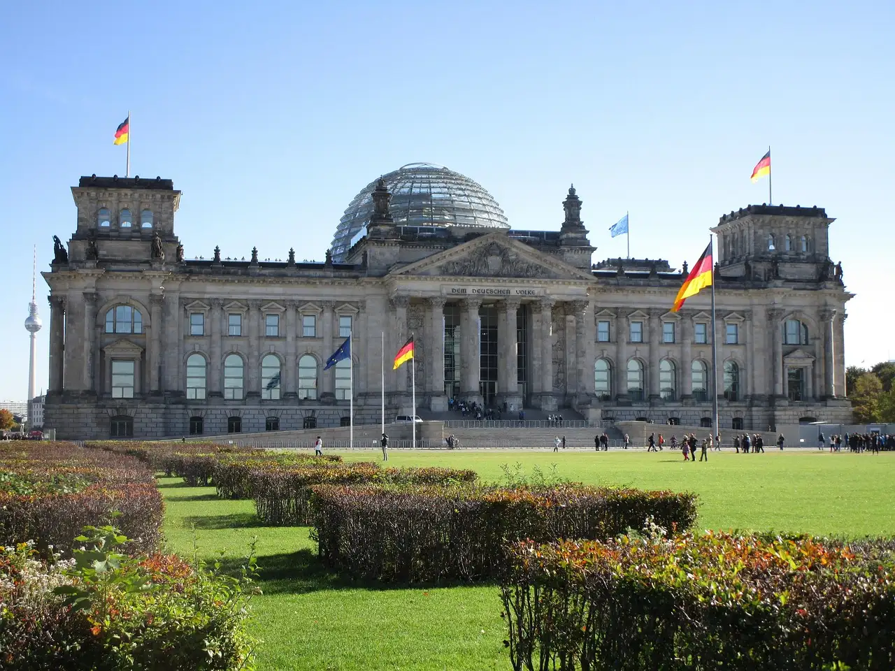 The Reichstag building and its glass dome behind a green lawn