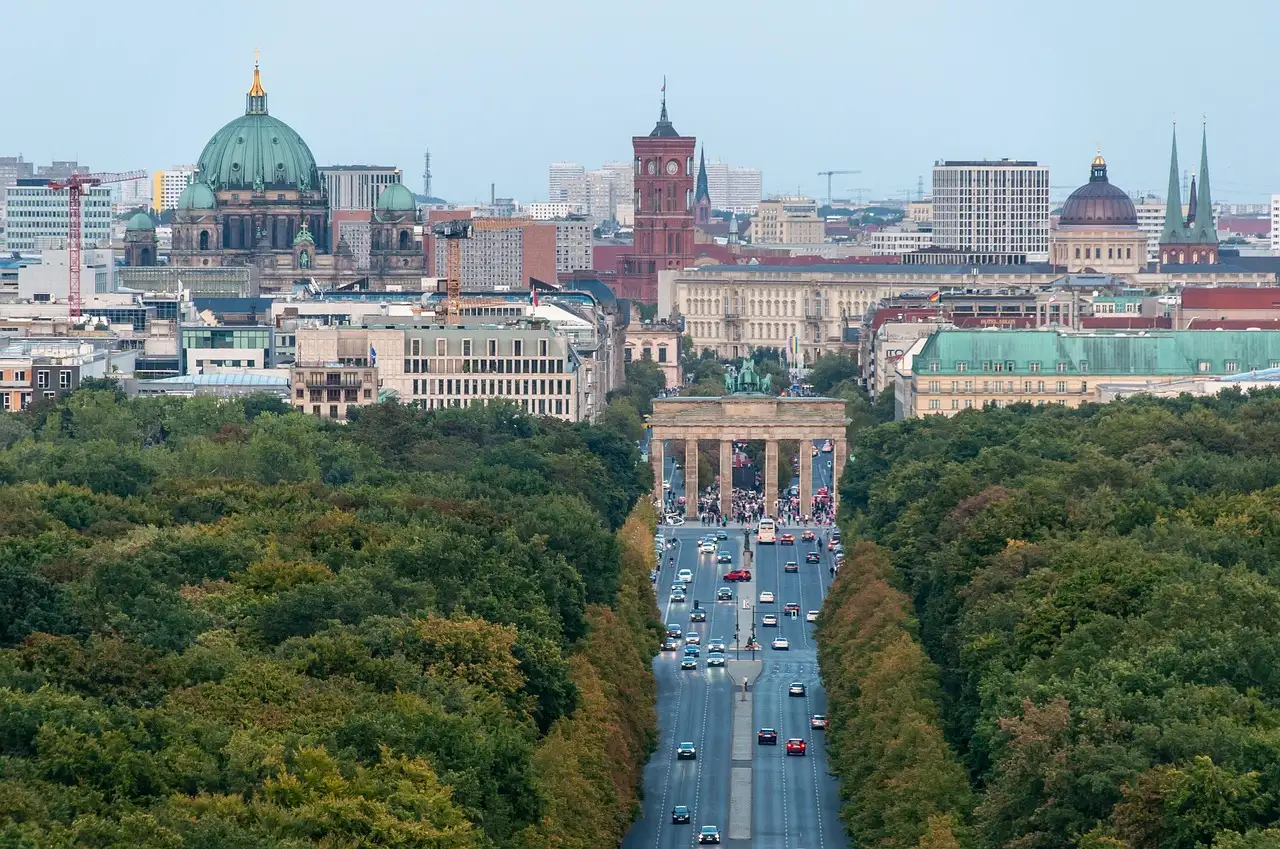View over the Tiergarten treetops to the Brandenburg Gate, Berlin Cathedral and the Red Town Hall