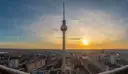 A view over Berlin at sunset from high above, with the TV Tower