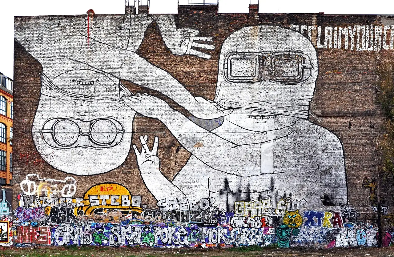 A huge black-and-white mural of a figure in goggles on a brick wall in Kreuzberg