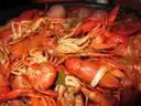 A pot of boiled red crawfish with potatoes, a Gulf Coast crawfish boil