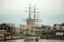 A tall sailing ship moored at a wharf in Galveston's harbor