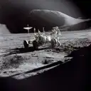 An astronaut next to the lunar rover on the gray surface of the Moon