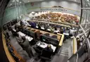 A NASA control room with rows of desks and screens, seen through a wide-angle lens