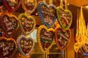Decorated gingerbread hearts hanging at a Christmas market stall