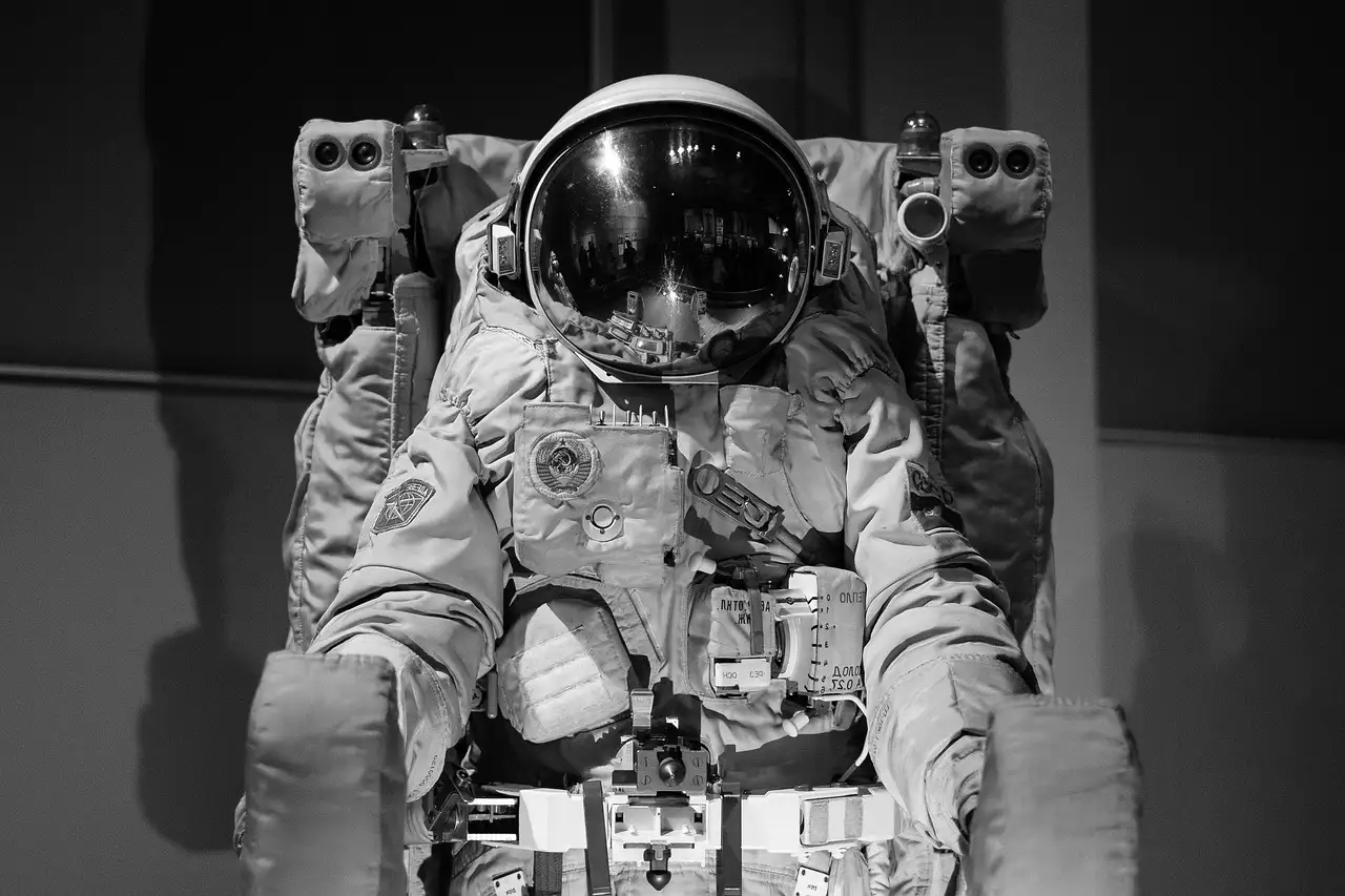 A black-and-white photo of a space suit on display