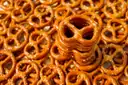 A pile of freshly baked Bavarian pretzels with coarse salt