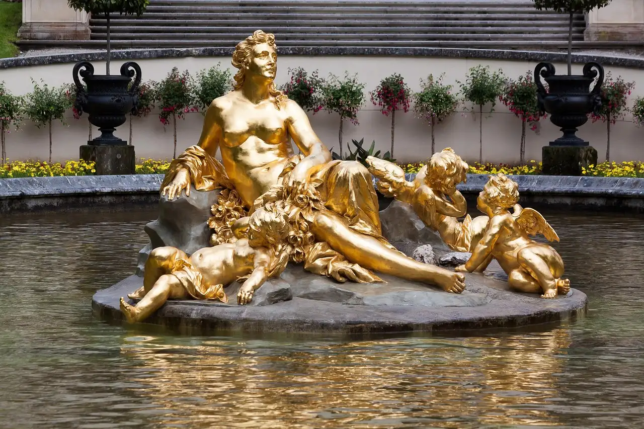 A gilded statue group in the fountain in front of Linderhof Palace