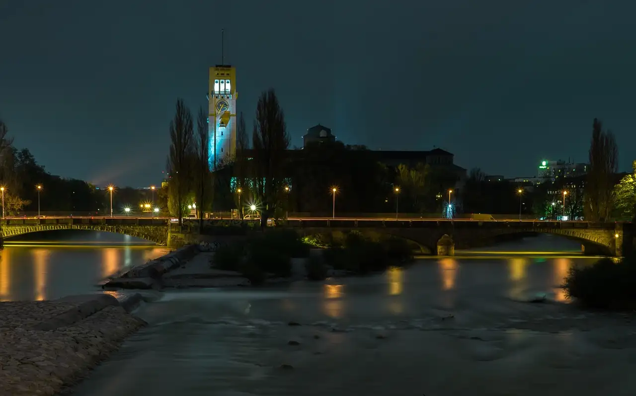 The Deutsches Museum tower lit up at night above the Isar