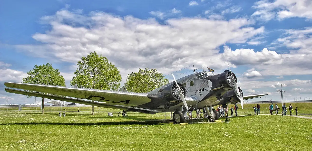 A vintage Ju 52 propeller plane on the grass at Munich Airport visitor park