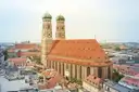 The Frauenkirche's two towers with green domes above the red roofs of Munich's Old Town