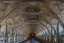 The long, vaulted Antiquarium hall in the Munich Residenz, with painted ceilings and rows of busts