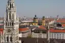 The New Town Hall tower above Munich's Old Town roofs, with the yellow Theatine Church behind