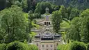Linderhof Palace and its terraced garden among green trees