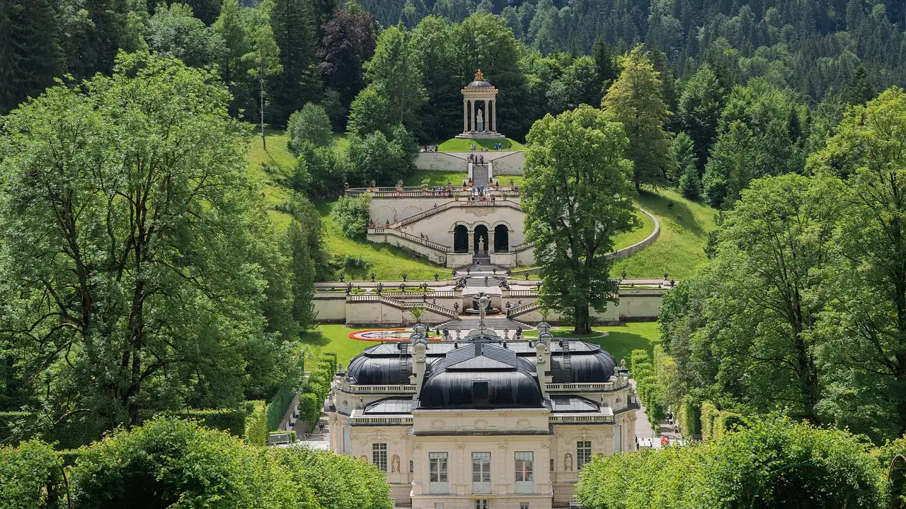 Linderhof Palace and its terraced garden among green trees