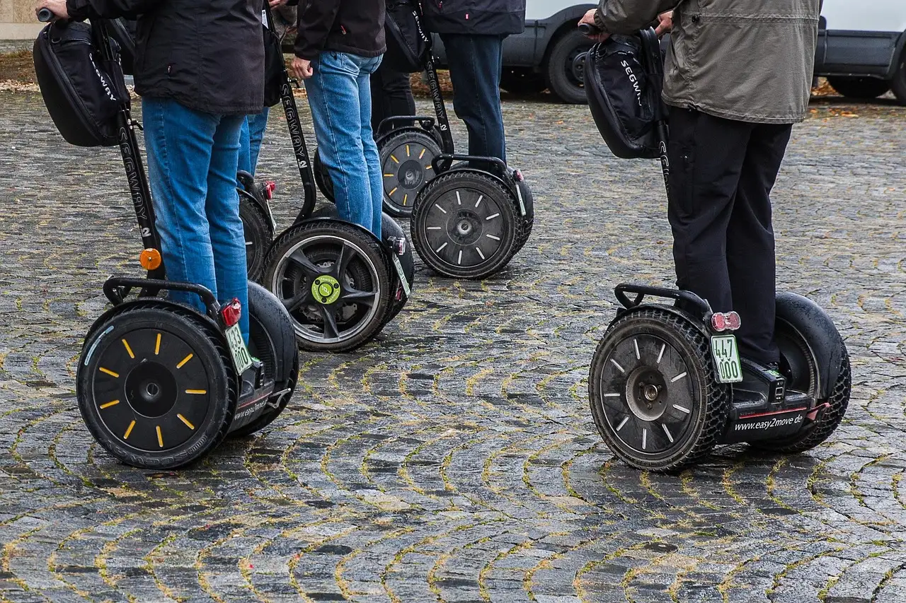 Several Segways standing on a cobblestone square