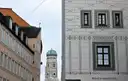 A Frauenkirche tower with its green dome, seen between Old Town house fronts