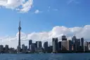 The CN Tower and the downtown Toronto skyline across the water on a sunny day