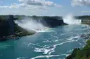 The American and Horseshoe Falls seen down the Niagara River on a sunny day
