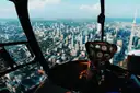Downtown Toronto and the CN Tower seen through the front window of a helicopter cockpit