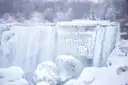 Niagara Falls in winter, with ice and snow piled on the rocks below