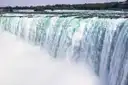 Green water pouring over the edge of the Horseshoe Falls