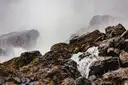 Rocks and thick mist at the foot of Niagara Falls