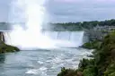 A tall column of mist rising from the Horseshoe Falls above the river