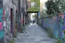 A narrow Toronto lane with graffiti on both walls