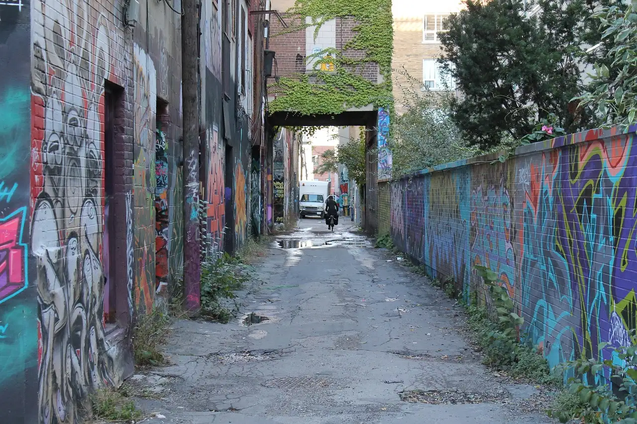 A narrow Toronto lane with graffiti on both walls