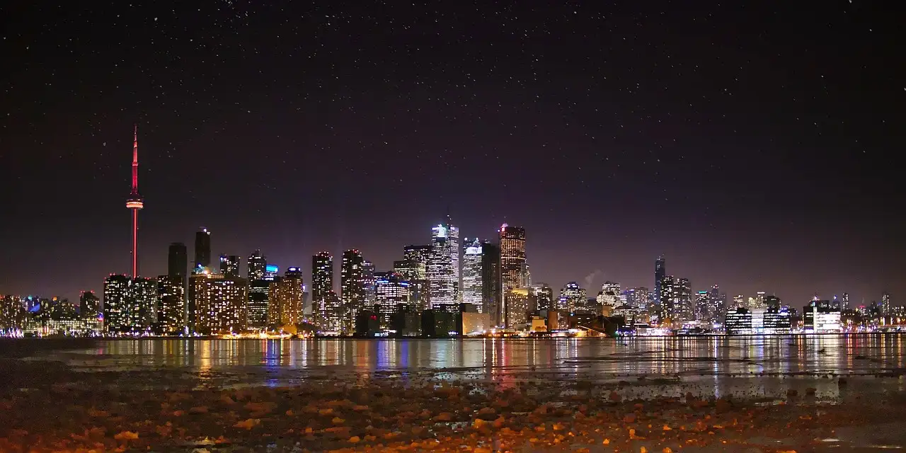 The Toronto skyline lit up at night across the harbour